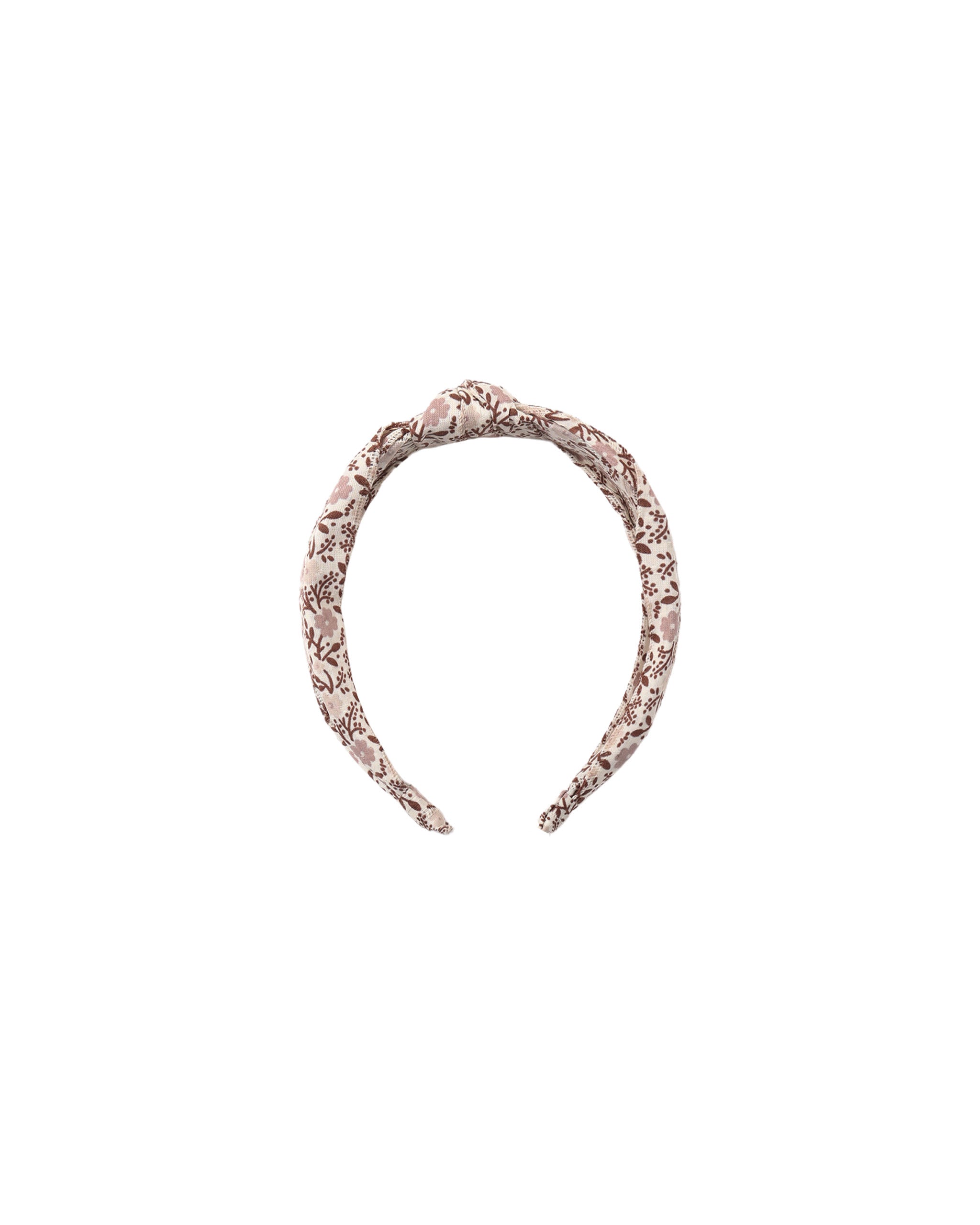 A twisted fabric headband in a dusty rose pink and white pattern, shown against a plain white background.