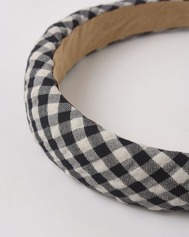 Black and white checkered headband with wooden band on a white background