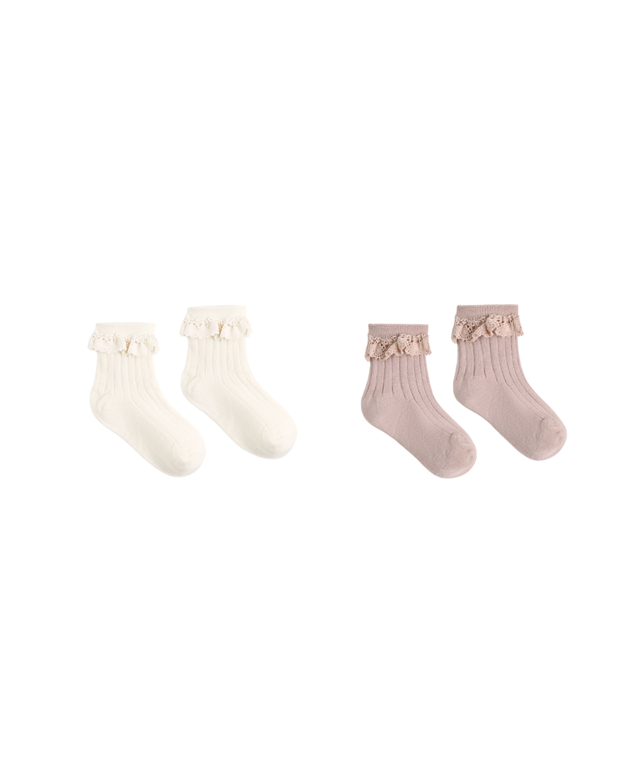 Two pairs of ribbed baby socks with ruffled trim, shown on a plain white background. One pair is off-white/cream and the other is dusty pink, both with small bow details at the top.