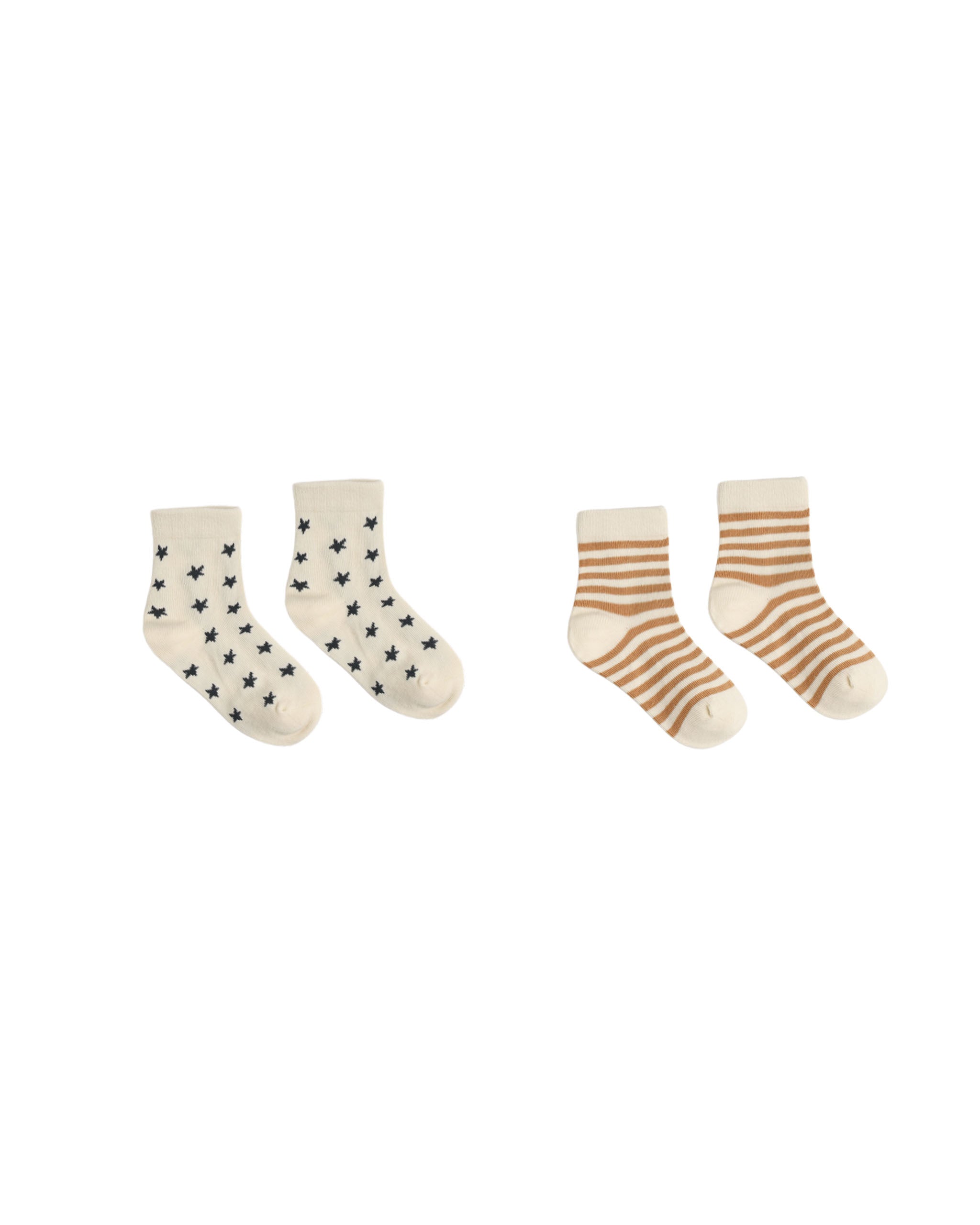 Two pairs of baby socks on a plain white background. The left pair is off-white with small black star patterns, and the right pair is cream with warm brown stripes.
