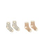 Two pairs of baby socks on a plain white background. The left pair is off-white with small black star patterns, and the right pair is cream with warm brown stripes.