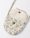 A small quilted crossbody bag with a floral patterned exterior and a solid cream-colored interior lining, featuring two metal snap buttons and a matching shoulder strap, shown on a plain white background.