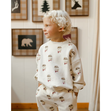 toddler boy wearing ivory sweatshirt with all over snowman print with matching sweatpants