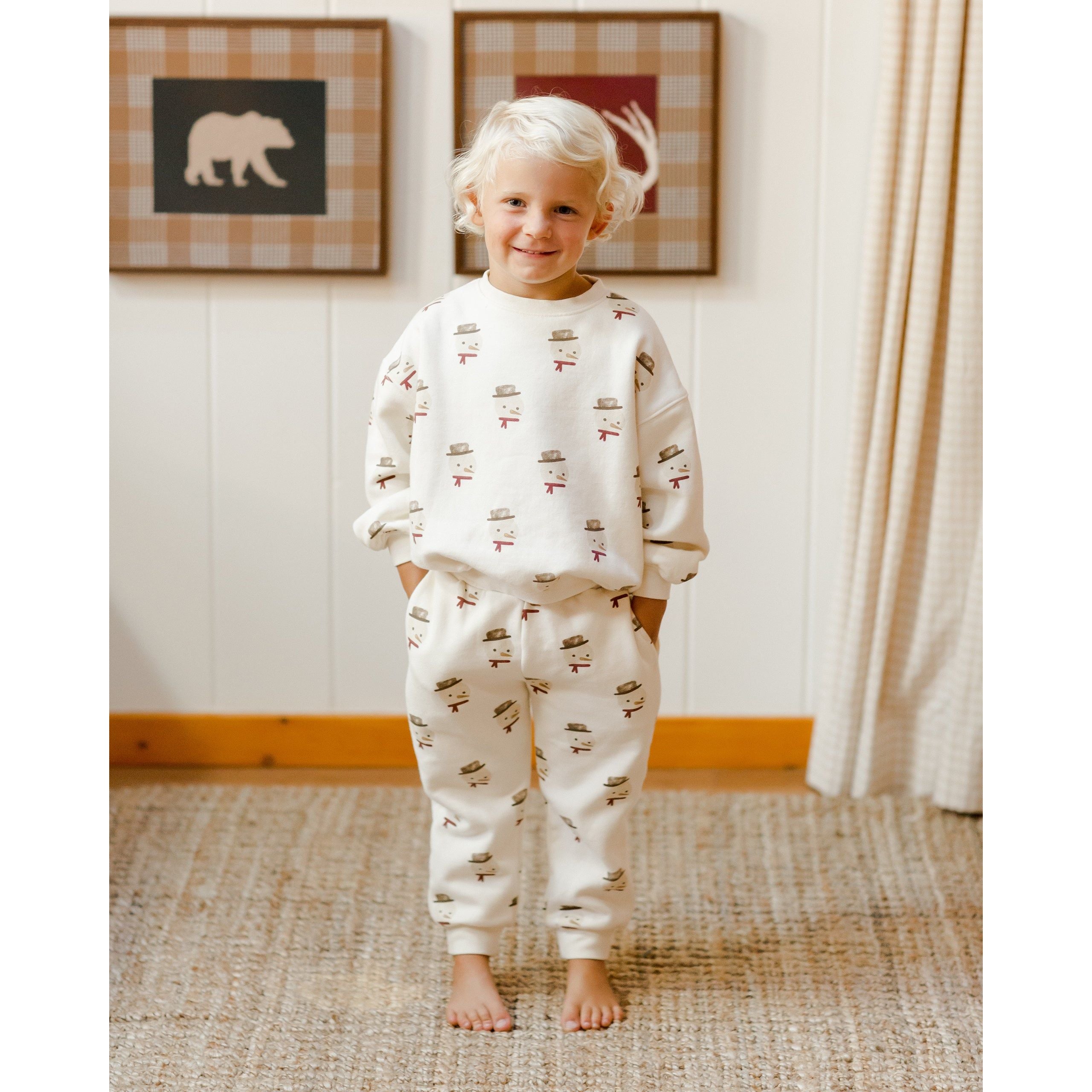 toddler boy wearing ivory sweatshirt with all over snowman print