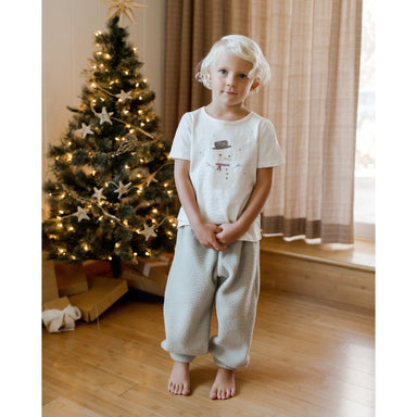boy wearing ivory short sleeve tee with snowman graphic