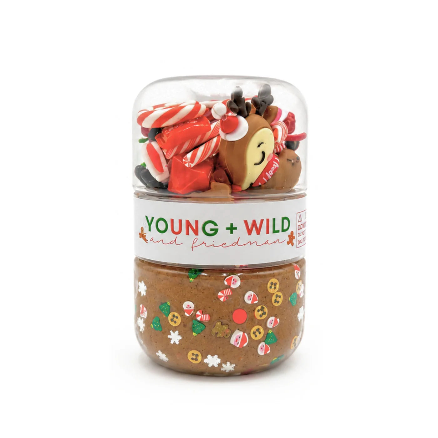 Reindeer sensory dough jar with brown holiday dough and a clear top compartment filled with festive trinkets by Young Wild and Friedman