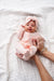 Baby in pink striped zipper footie
