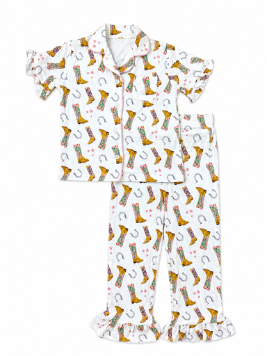 A two-piece children's pajama set featuring a short-sleeve button-up top and matching ruffled pajama pants, both printed with a western boot and horseshoe pattern on a white background.