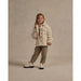 girl wearing cream colored fleece chore coat with button up front