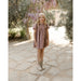 girl wearing plum floral puff sleeved babydoll dress
