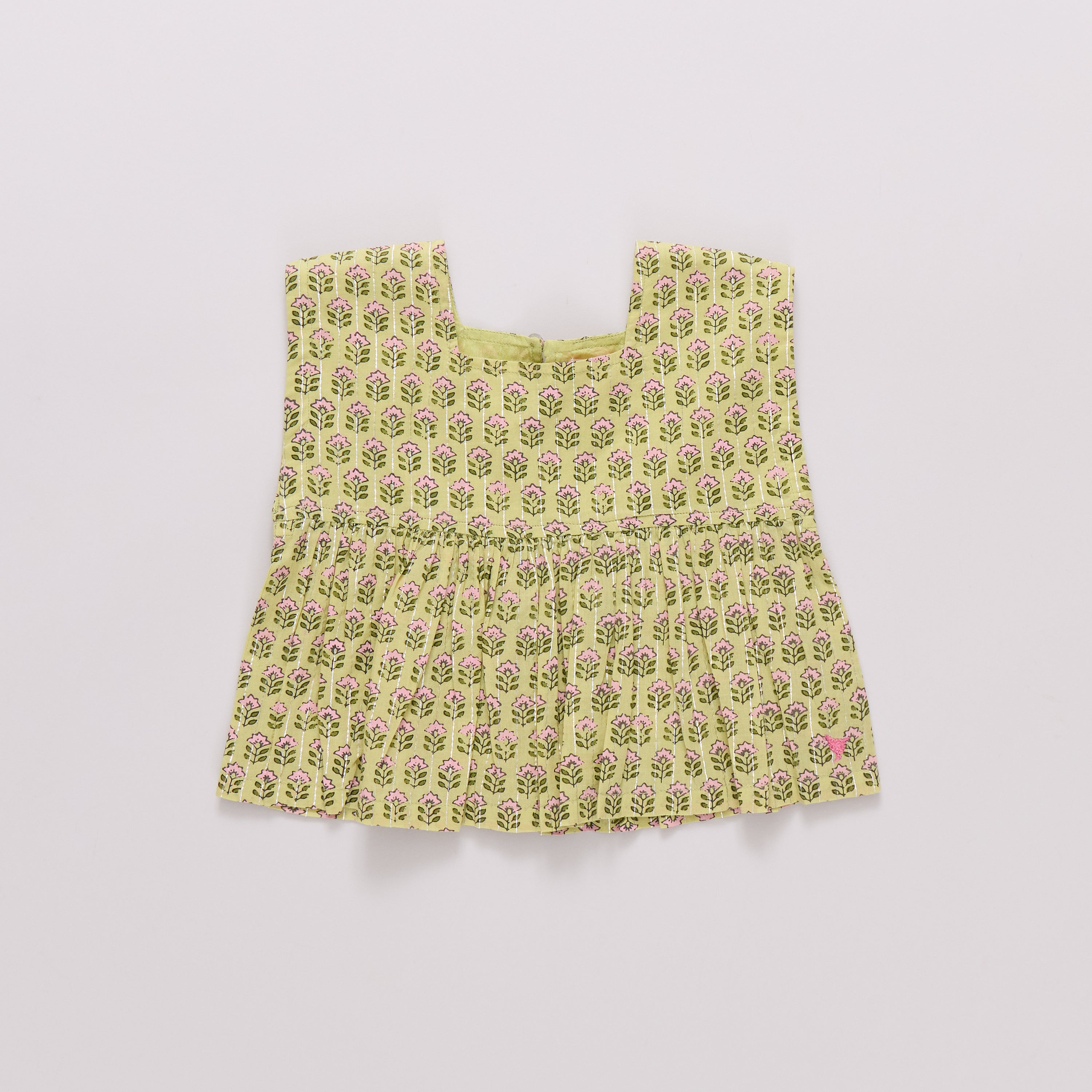Yellow floral patterned top on a light gray background