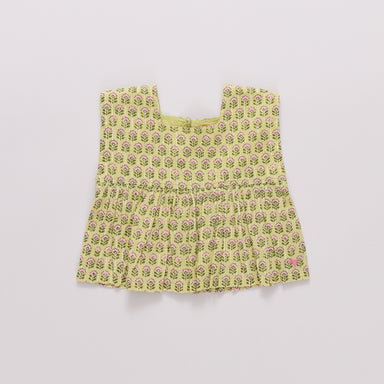 Yellow floral patterned top on a light gray background