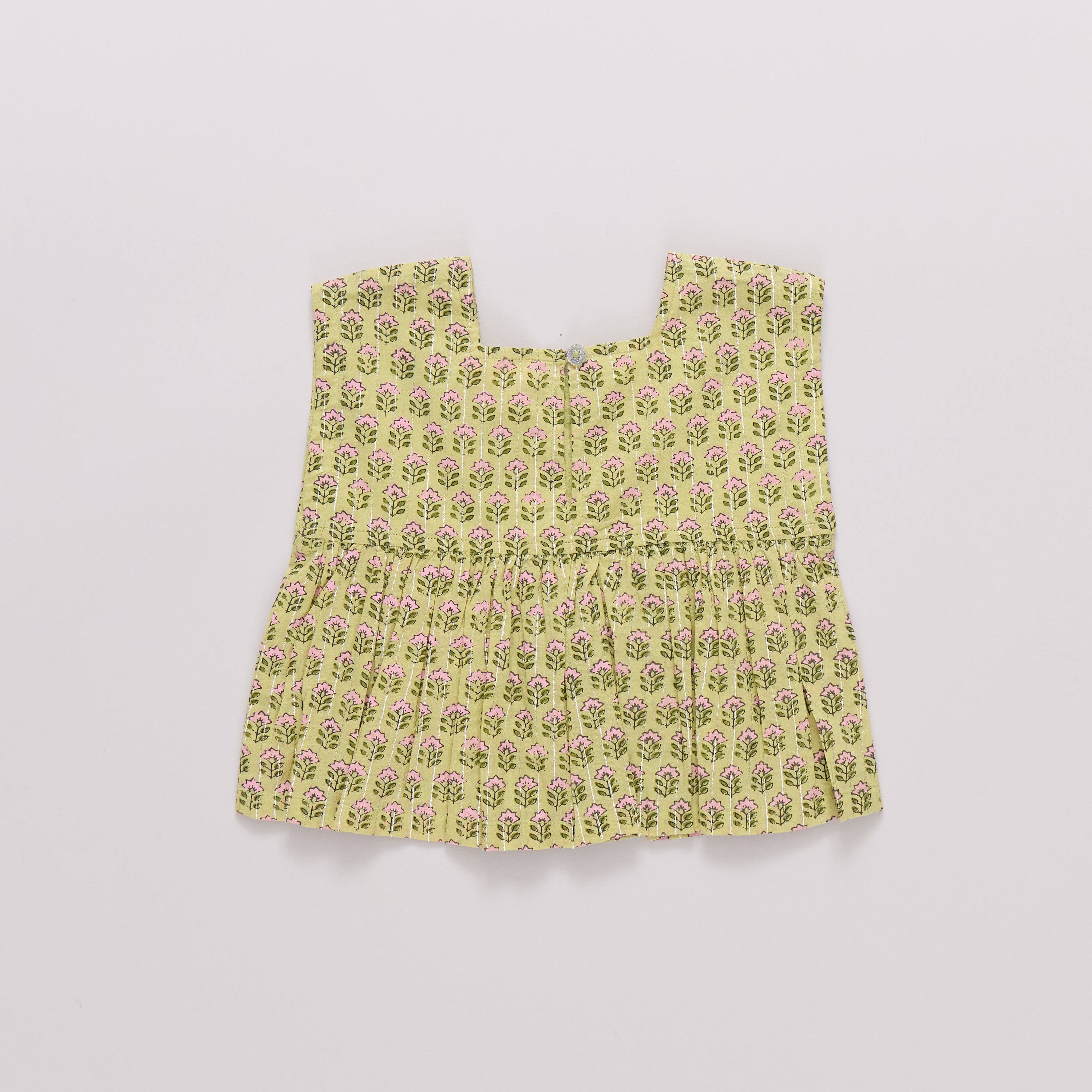 Yellow floral patterned baby dress on a light gray background