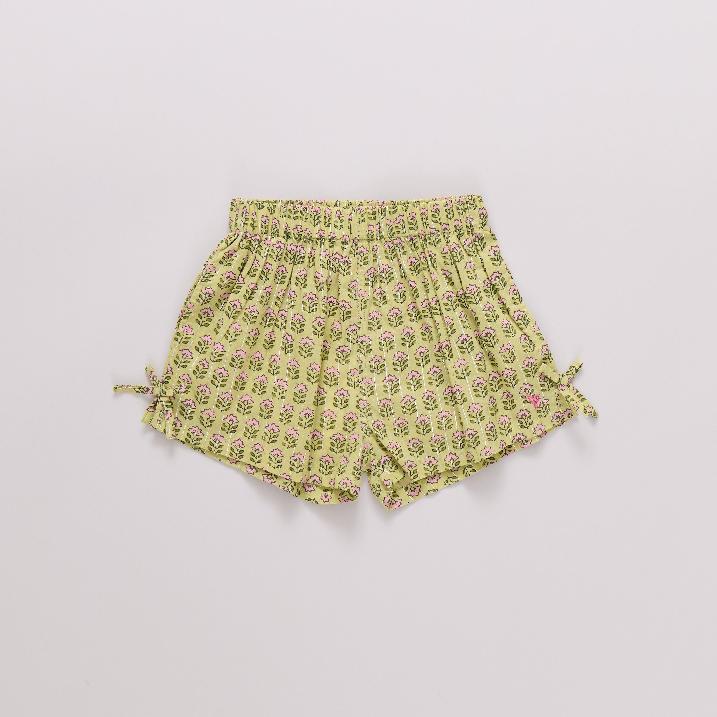 Yellow floral shorts on a light gray background