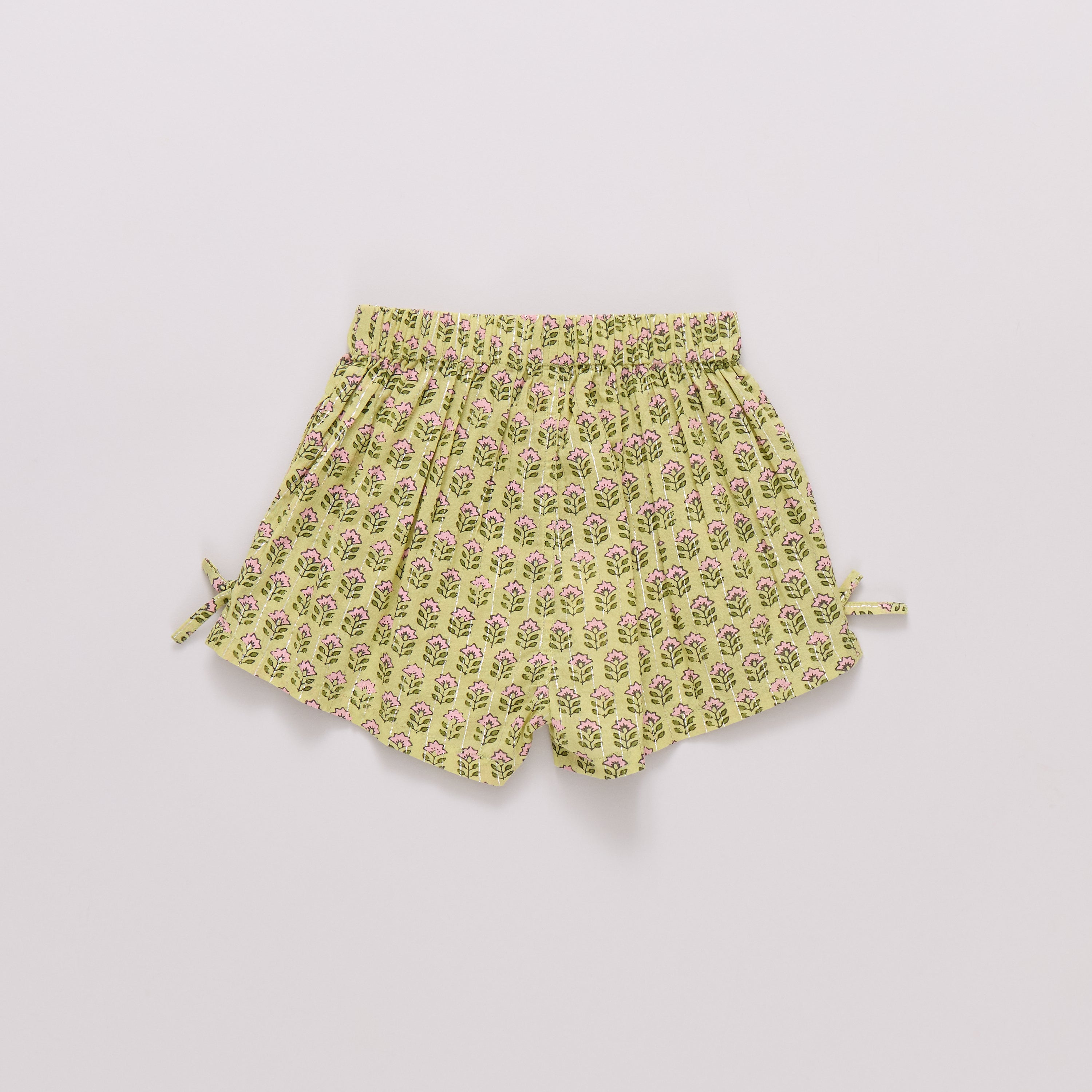 Yellow floral shorts on a light gray background