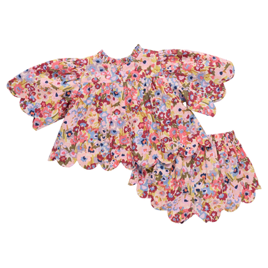 Floral top with baby shorts on a white background