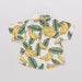 Baby romper with banana leaf pattern on a light gray background