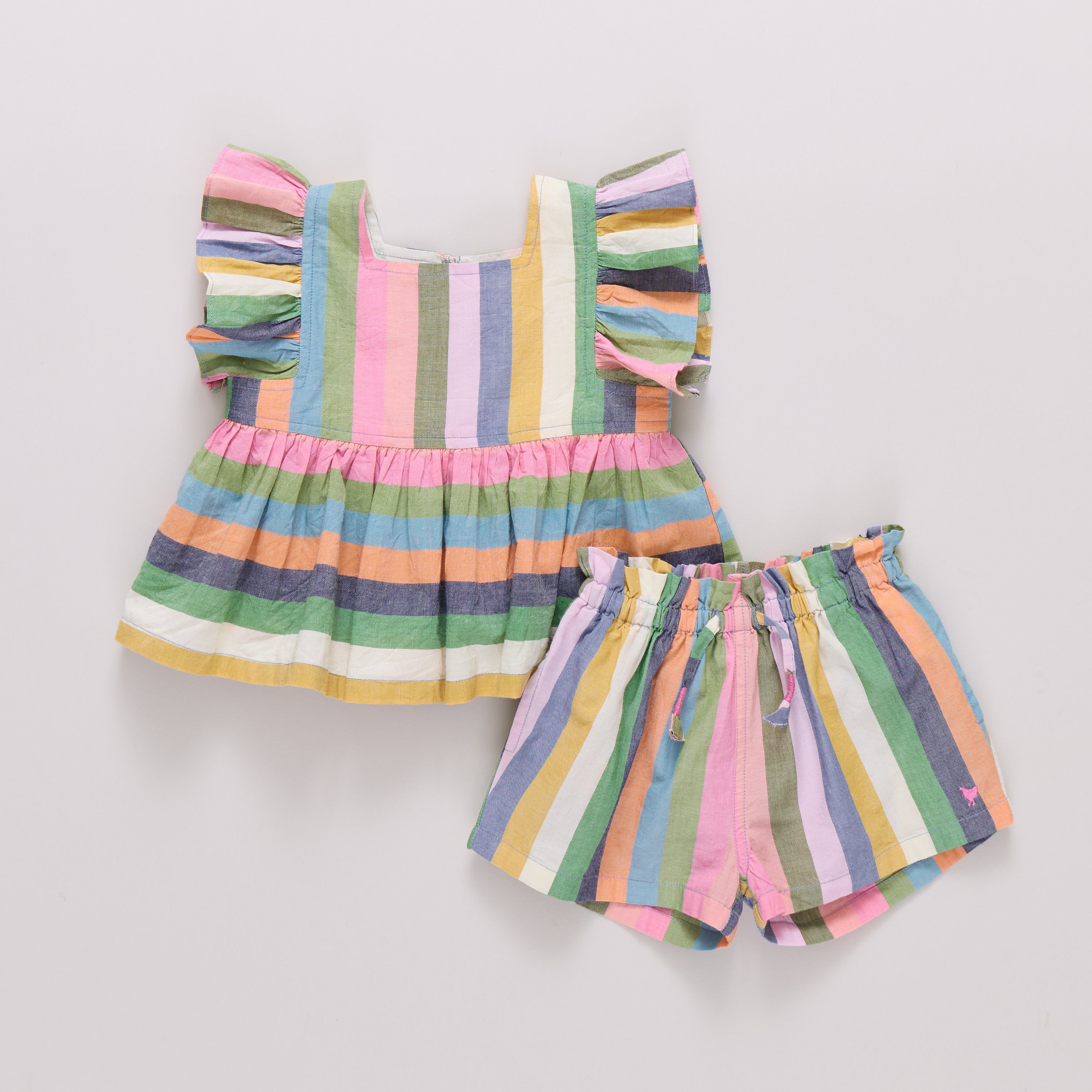 Colorful striped shirt and shorts set on a light gray background