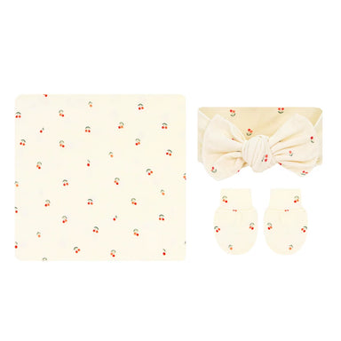 Baby set featuring a cream-colored blanket, a matching headband with a large bow, and a pair of mittens, all decorated with a small cherry print.