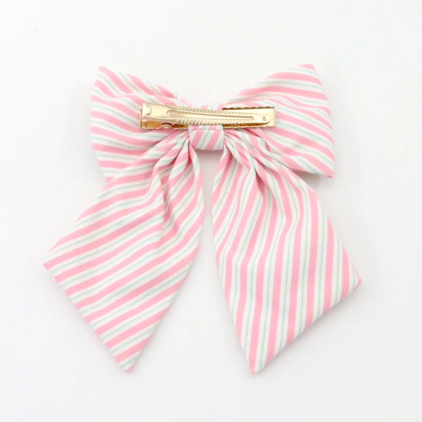 A pink and white striped fabric hair bow with a gold metal spring clip, shown on a plain white background.