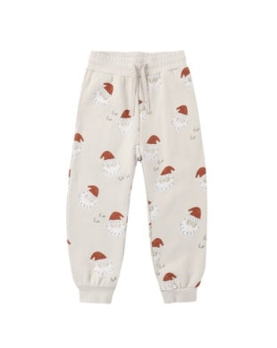 Beige sweatpants with Santa Claus faces on a white background