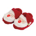 Red Santa Claus slippers with white faces and red noses on a white background
