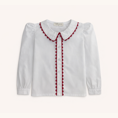 A white long-sleeve blouse for toddlers, featuring a Peter Pan collar and front placket trimmed with red scalloped fabric, shown against a light cream background.