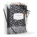 Black and white patterned notebook with 'A New Chapter Begins' label in a clear box on a white background