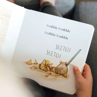Children's book titled 'Scribble Scrabble' with illustrations of a child drawing and text.