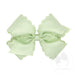 Light green hair bow with lace details on a white background