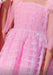 Close-up of a pink dress with a grid pattern