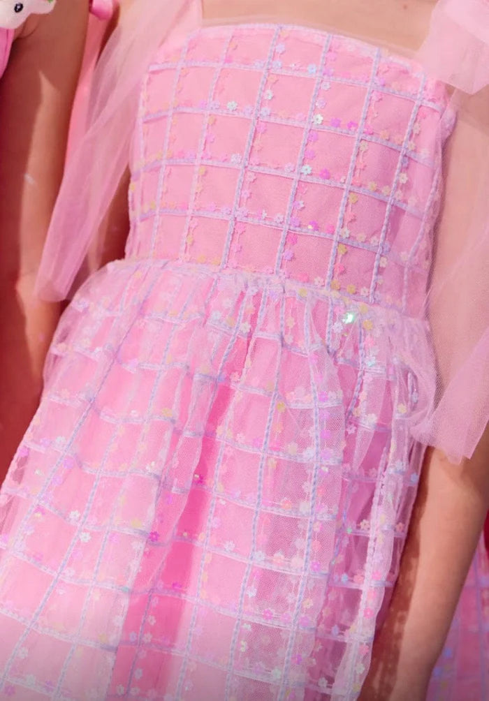 Close-up of a pink dress with a grid pattern