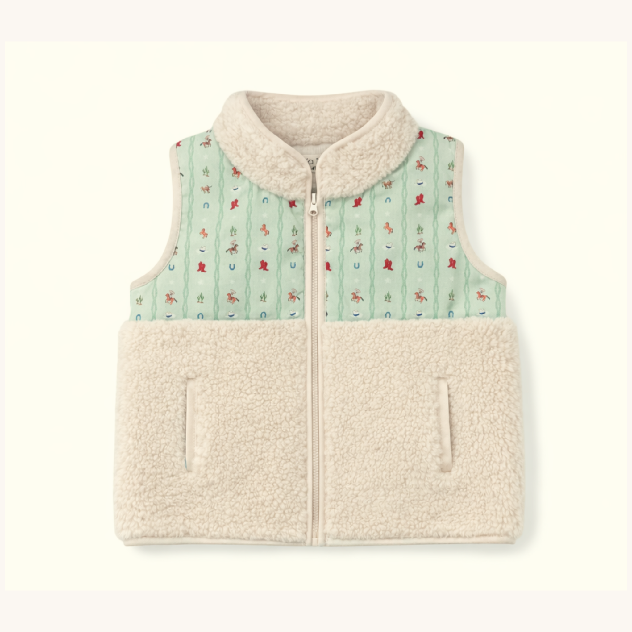 A sleeveless zip-front fleece vest with a light beige sherpa collar and lower body, and a mint green upper panel printed with small rodeo motifs, shown on a plain light background.