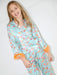 Young girl wearing a colorful pajama set on a white background