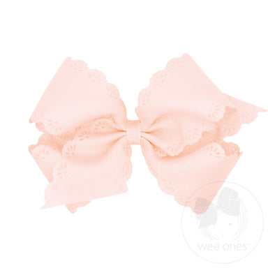 Large pink bow with a white background