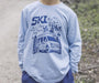 Boy wearing a long sleeve tee with a Ski Ya Later graphic on the front