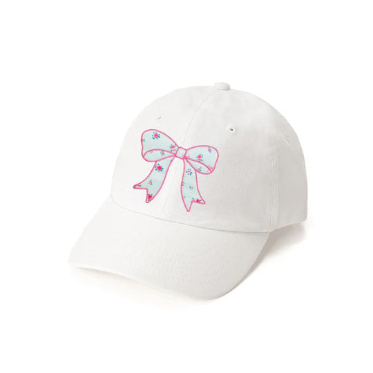 White cap with a pink bow design on a white background