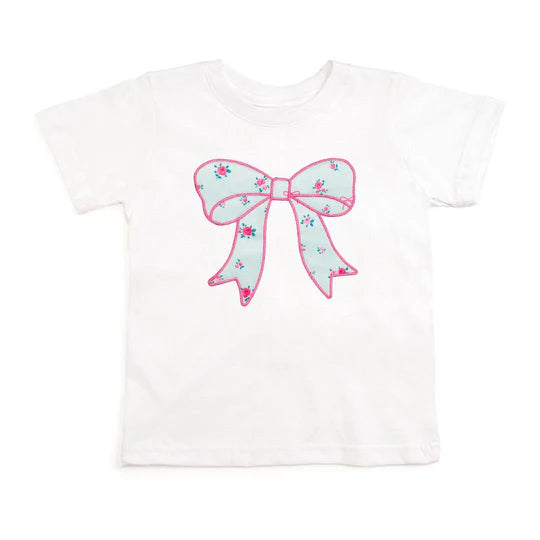 White t-shirt with a large pink and floral bow design on a white background