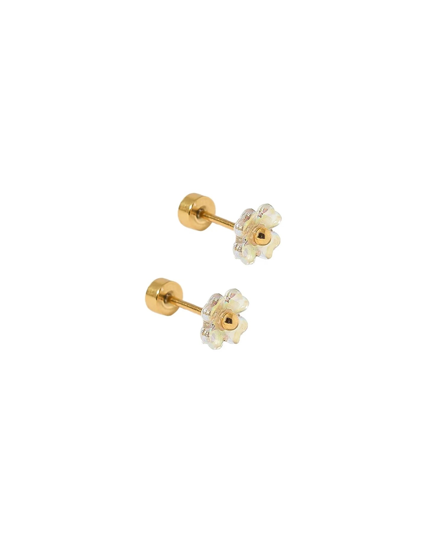 Pair of gold earrings with clear gemstones on a white background