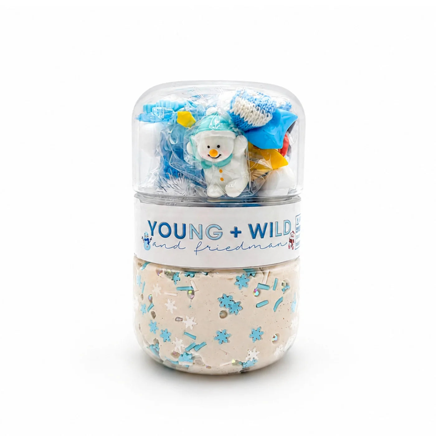 Snowman sensory dough jar by Young Wild and Friedman with beige dough blue snowflake sprinkles and a clear top compartment of winter themed play accessories