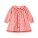 A pink gingham long-sleeve baby dress with red ruffled trim on the collar and hem, featuring a button-up front and small floral prints.