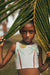 Young girl in a tropical bikini with palm leaves and a blurred 