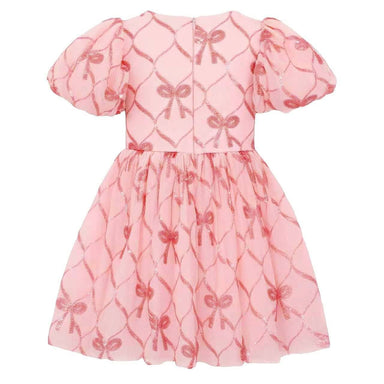 A pink short-sleeve dress with puff sleeves and a gathered tulle skirt, featuring an allover repeating pattern of shiny metallic bow motifs over a subtle diamond lattice background.