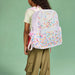 Girl with a pink Sprinkles Kane Backpack on her back