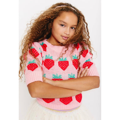 girl wearing pink puff sleeve sweater with knit strawberries