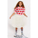 girl wearing pink puff sleeve sweater with knit strawberries with white tulle skirt