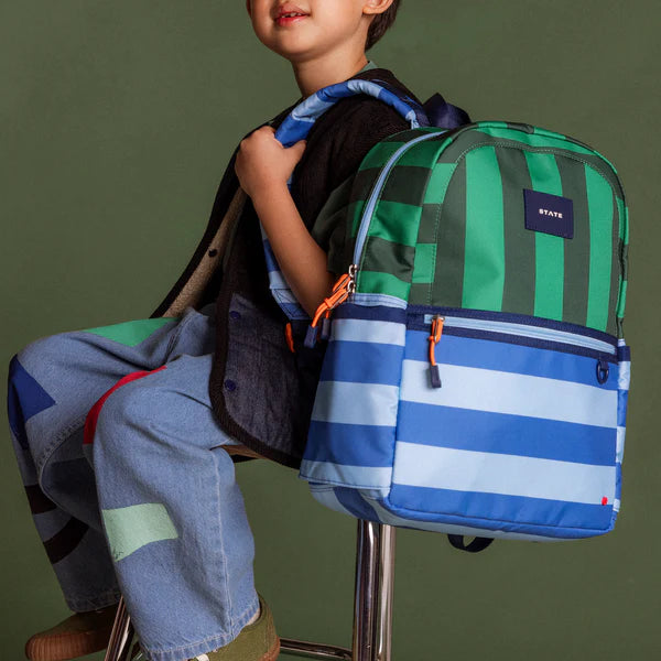 Boy carrying a blue and green Stripe Kane Backpack