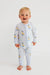 Baby wearing a light blue onesie with duck pattern on a white background