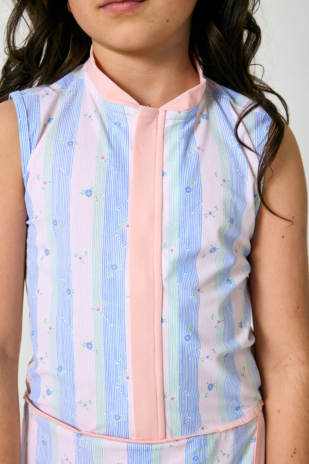 Pastel striped sleeveless top worn by a person against a neutral background