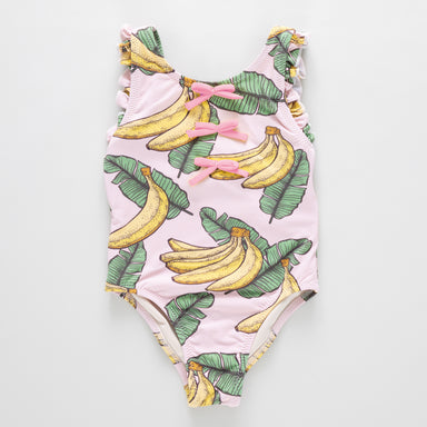 One-piece swimsuit with banana and leaf pattern on a light pink background